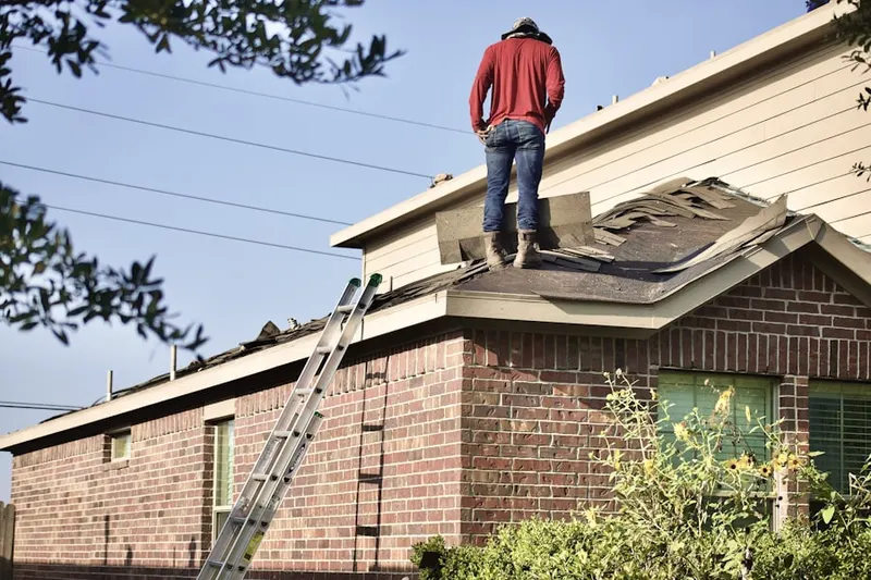 Professional roofer working on a residential roof in Brookhaven